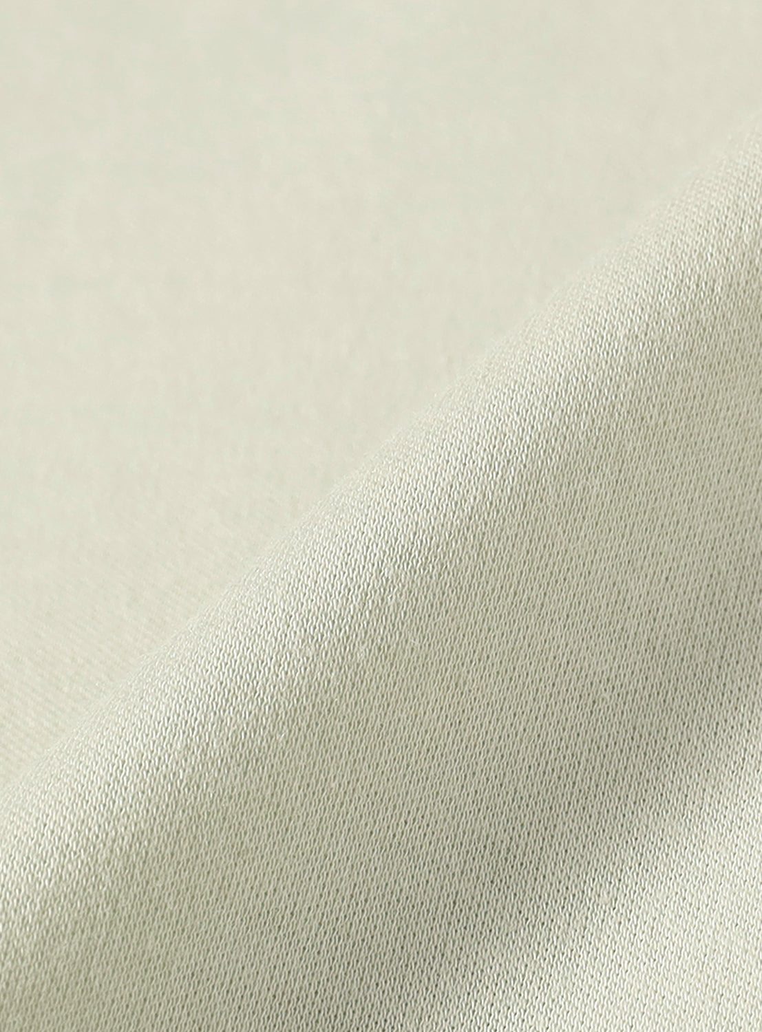 Close-up of the mint green fabric, highlighting the texture of the material.