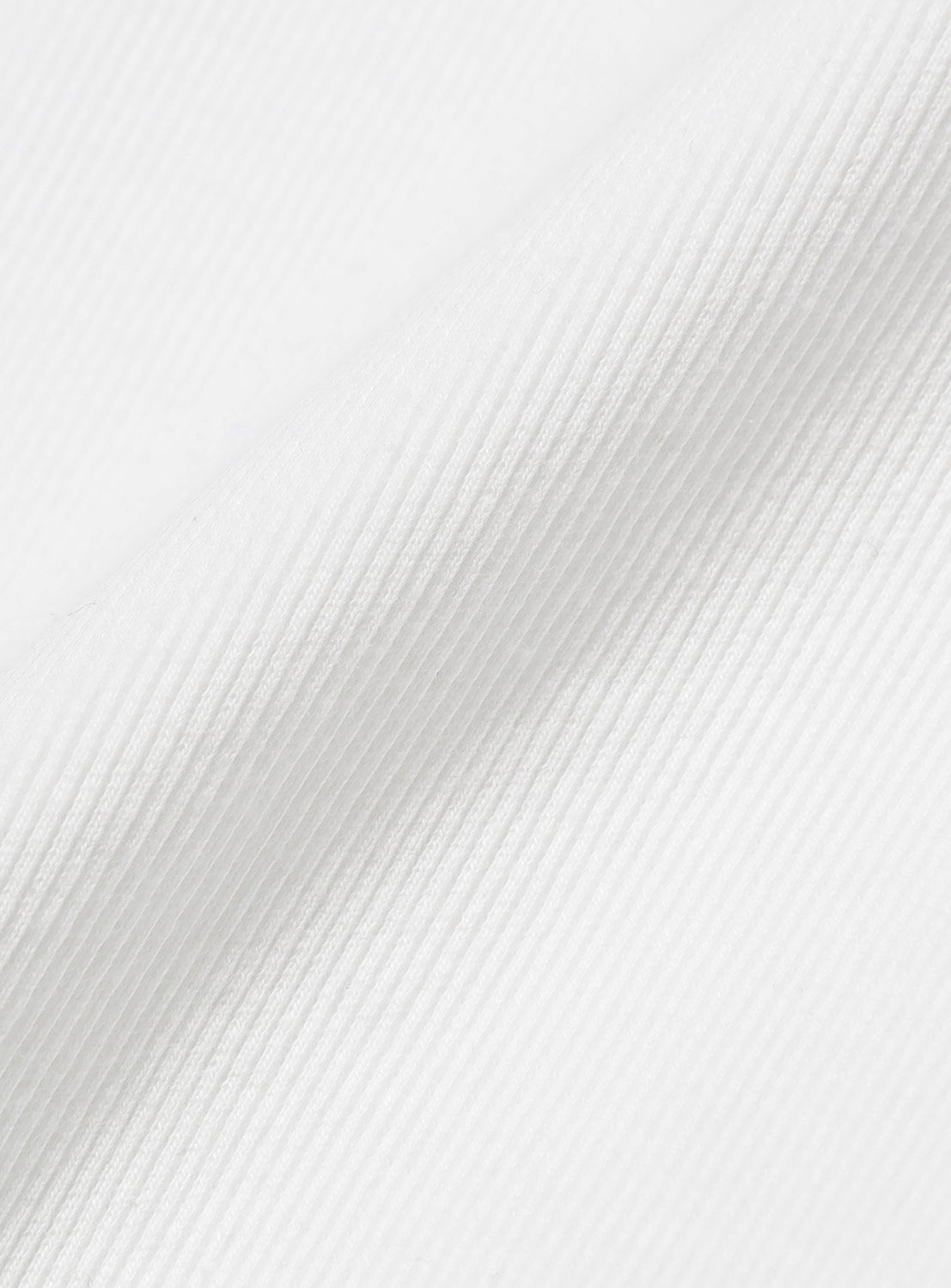 Close-up of the white knit fabric, revealing the distinct ribbed pattern.