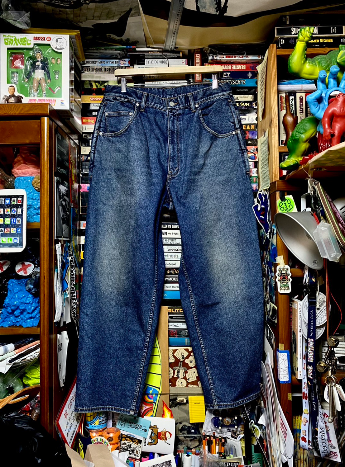 Blue denim pants with a smart twist on a classic silhouette, hanging in a store.