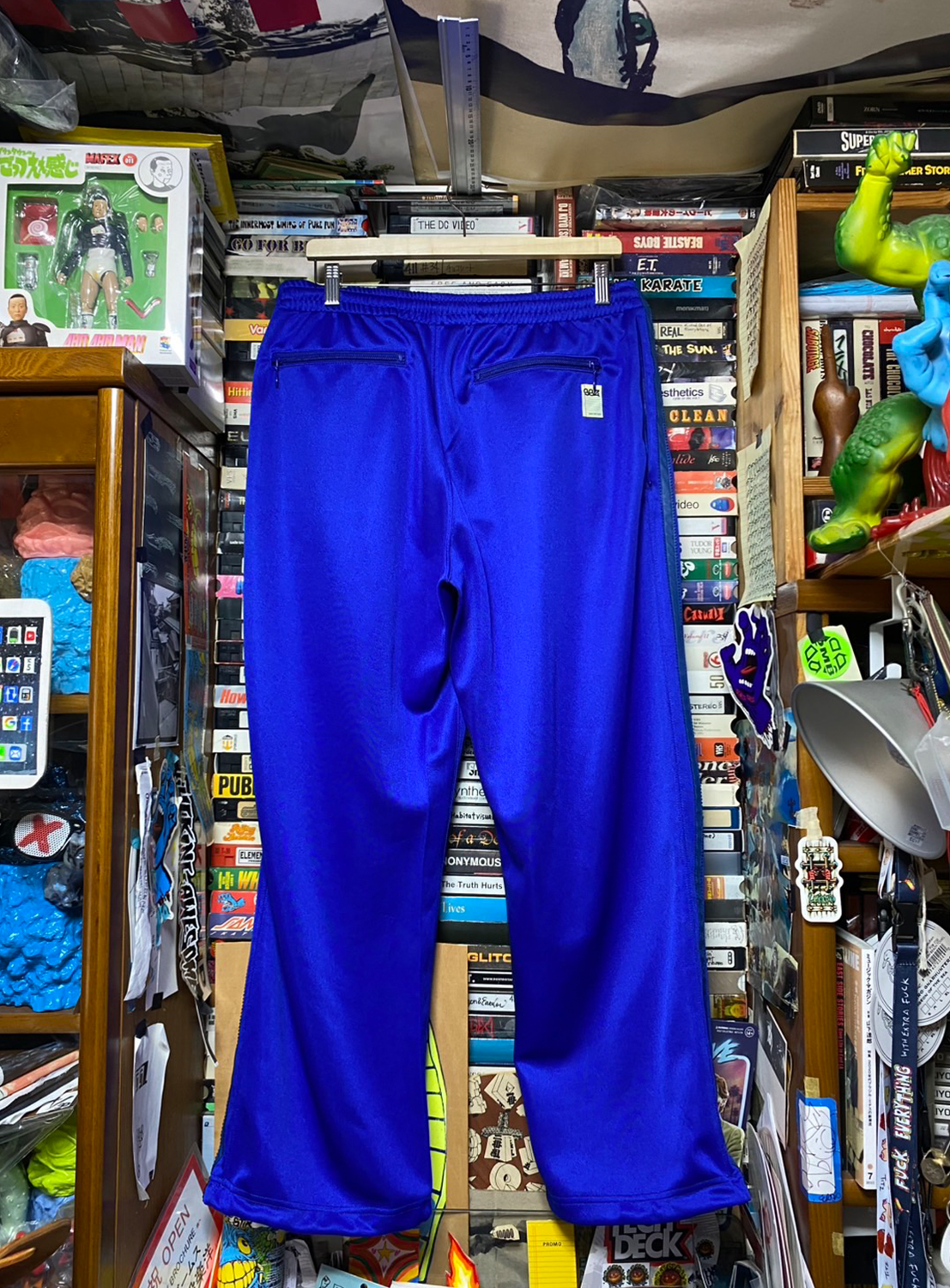 Back of blue track pants, highlighting the full silhouette and effortless utility.