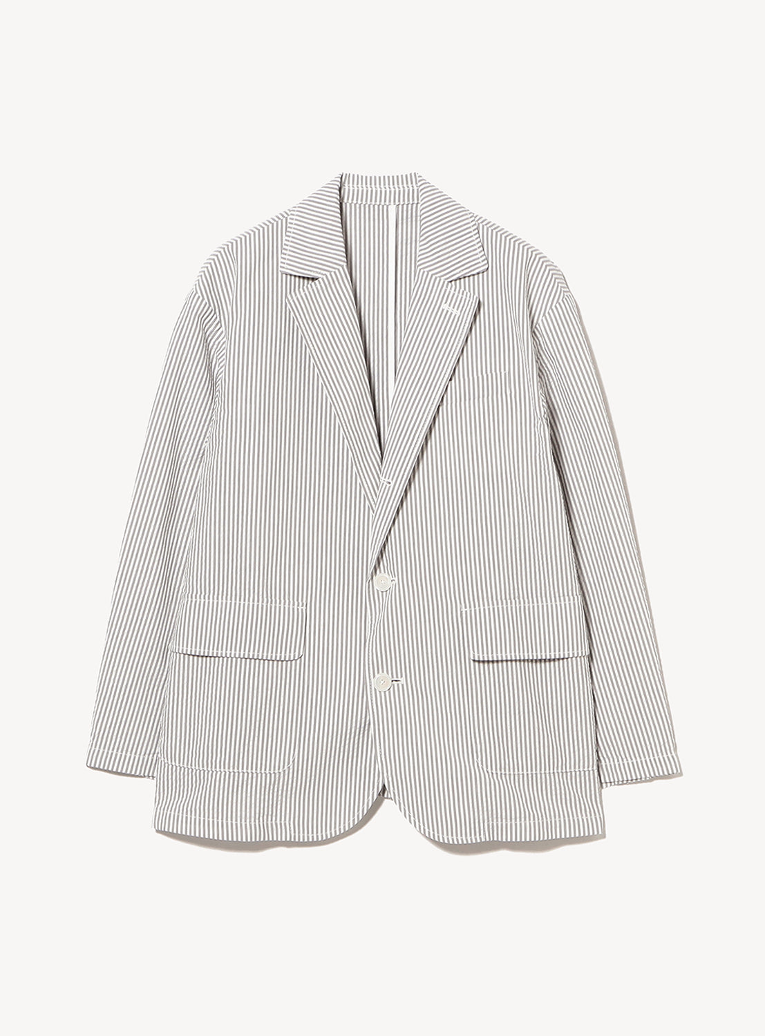 The BEAMS BOY Seersucker Jacket is a lightweight white blazer with thin vertical black stripes, featuring a notched lapel, two front pockets, and a single-button closure—an ideal piece inspired by classic summer prep style, shown against a plain white background.