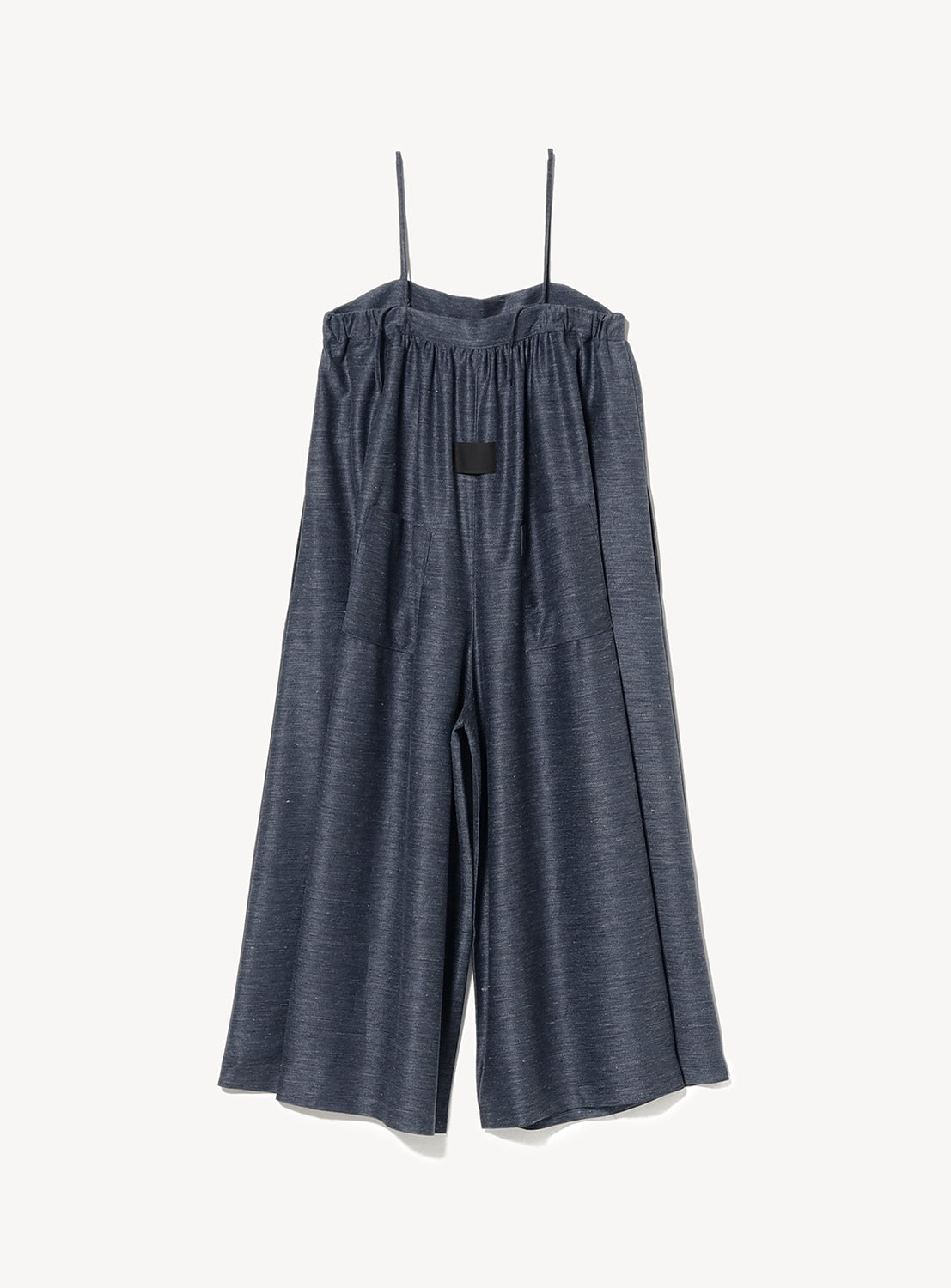 Back of a blue overall jumpsuit with thin straps and back pockets.
