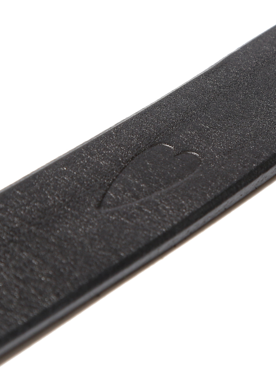 A black belt with a heart stamped into the belt.