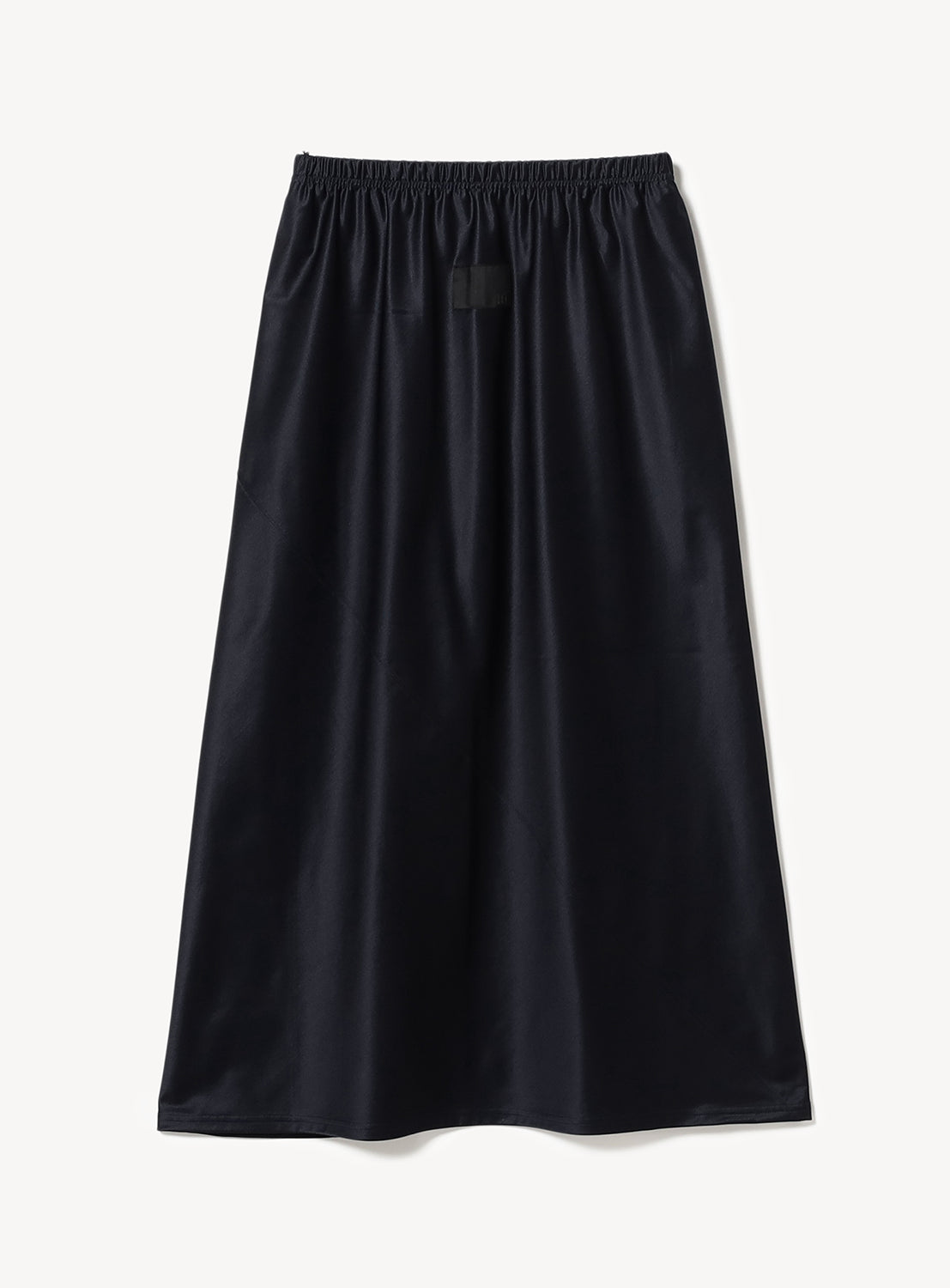 Back of solid black mid length flare skirt.