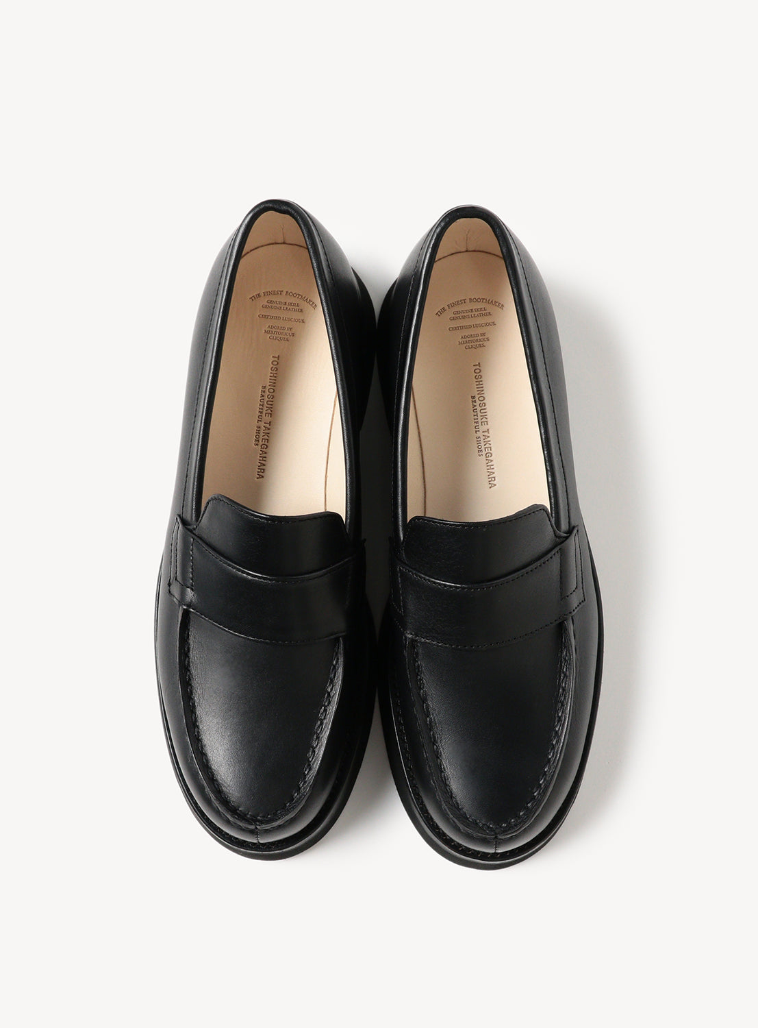 Top down view of black leather loafers.