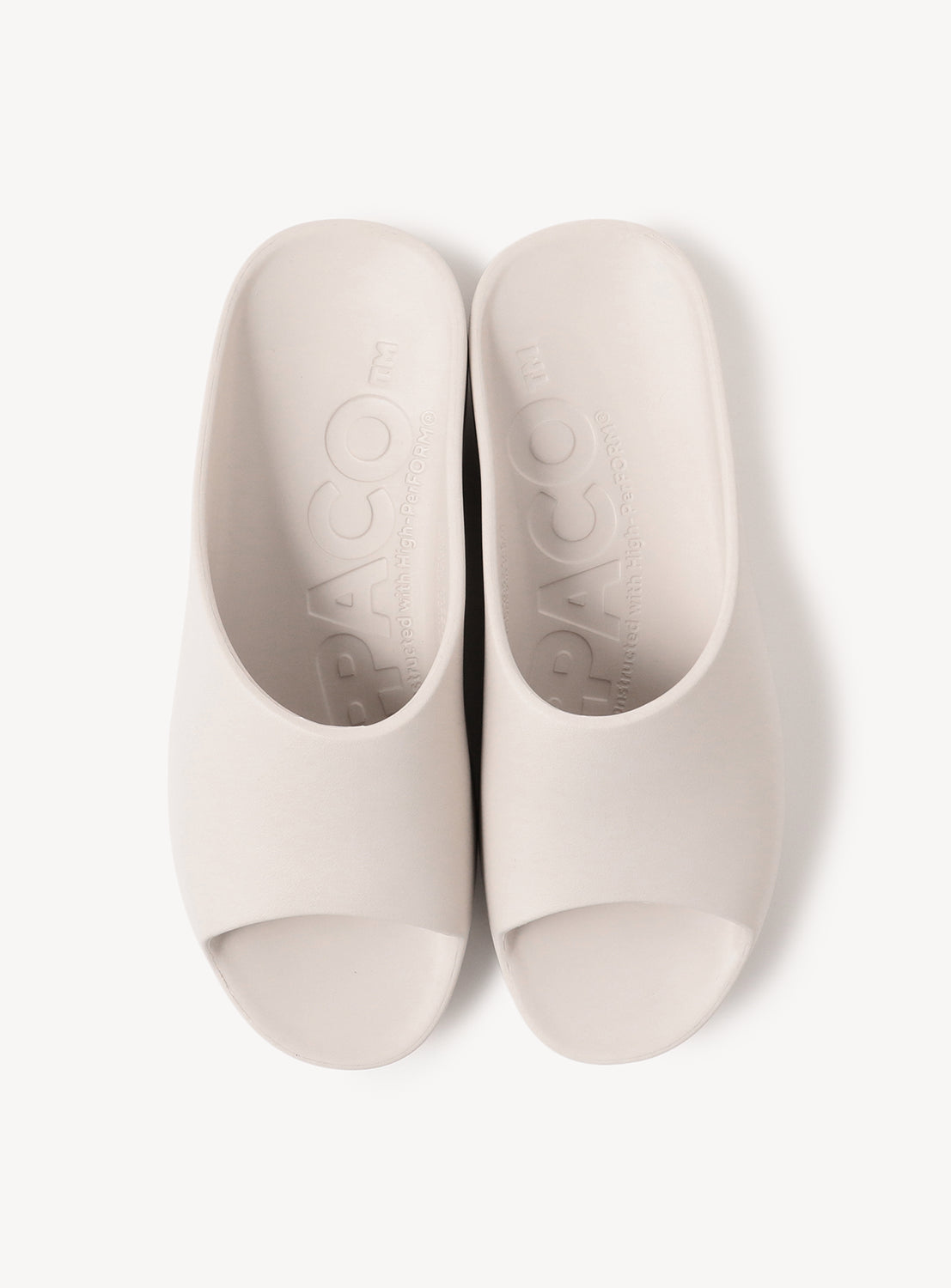Top-down view of a pair of off-white slides, showcasing the footbed and full shape.