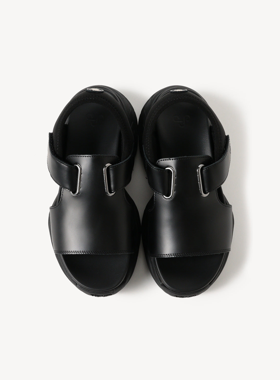 Top-down view of a pair of black chunky sole sandals, displaying the wide straps and textured sole.