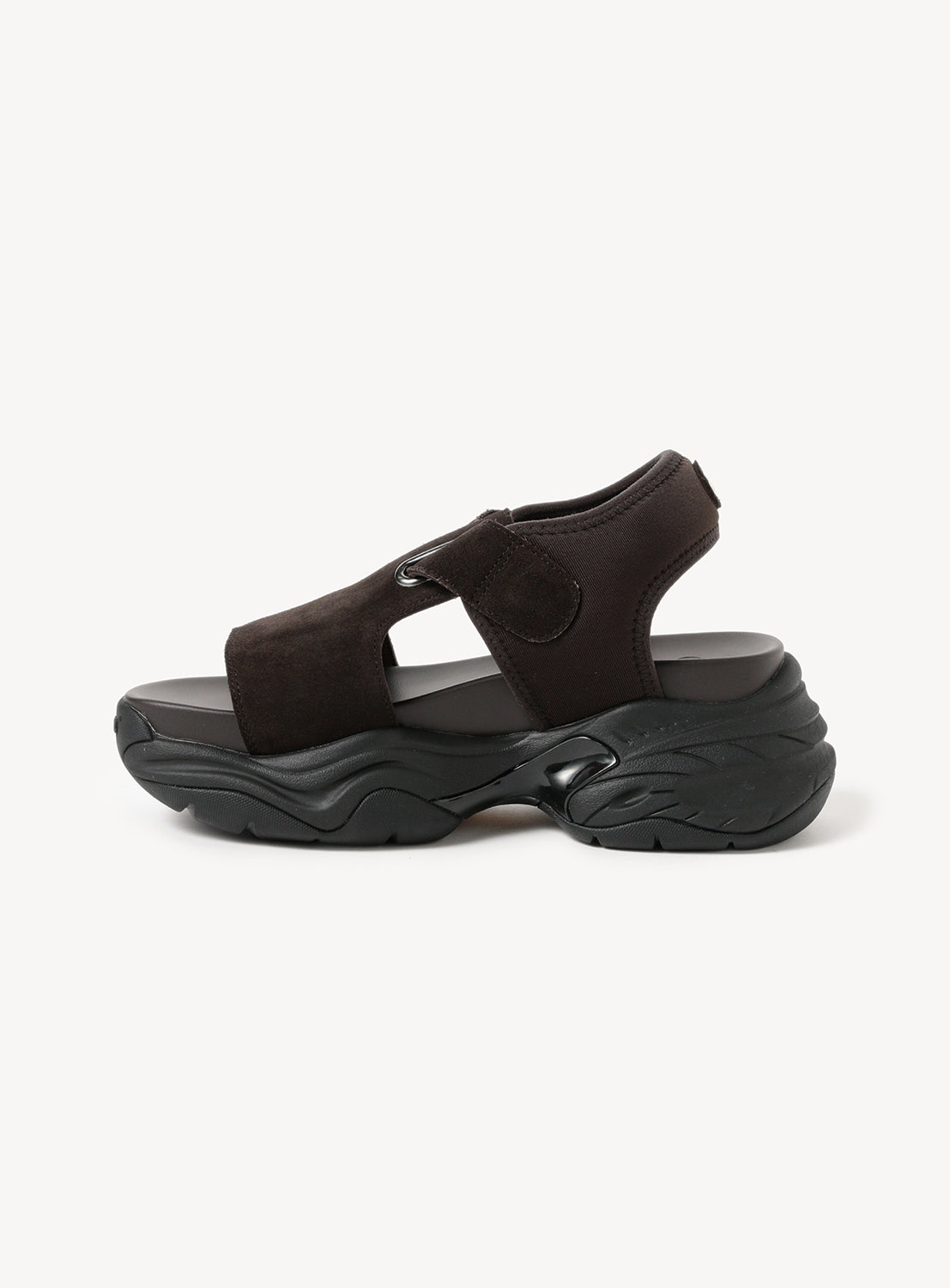 Single brown chunky sole sandal, side view, highlighting its thick sole and adjustable straps.