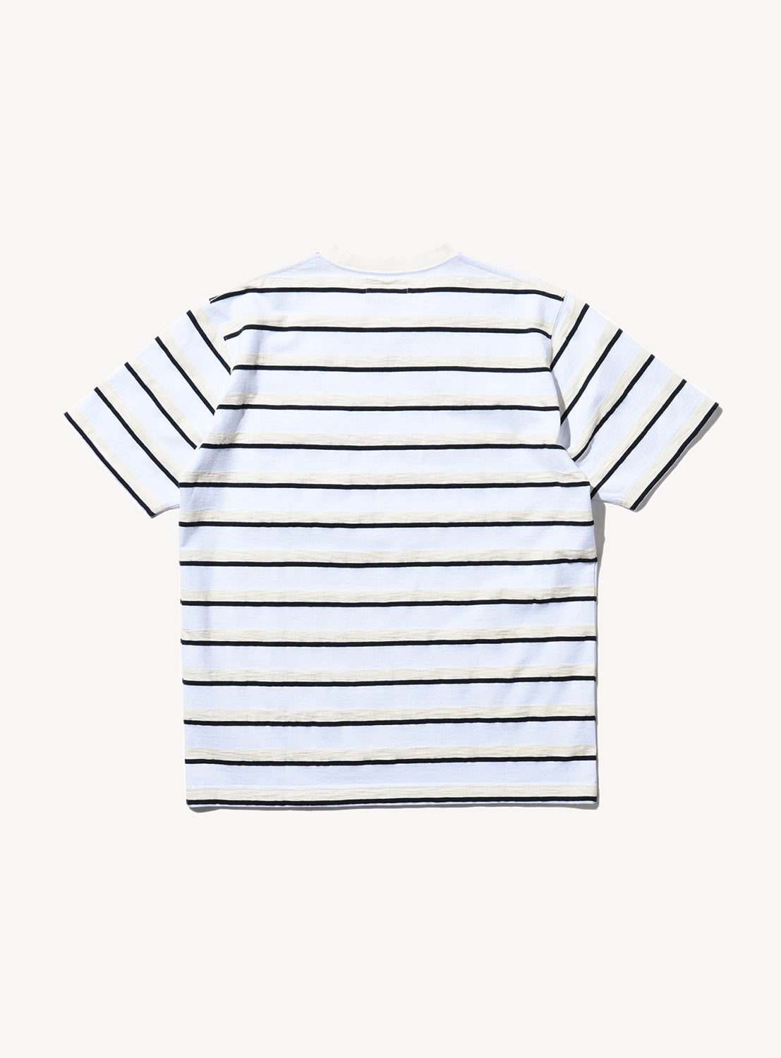 Back of a striped Pocket Tee Stripe in white and beige, and black, with short sleeves and a collar