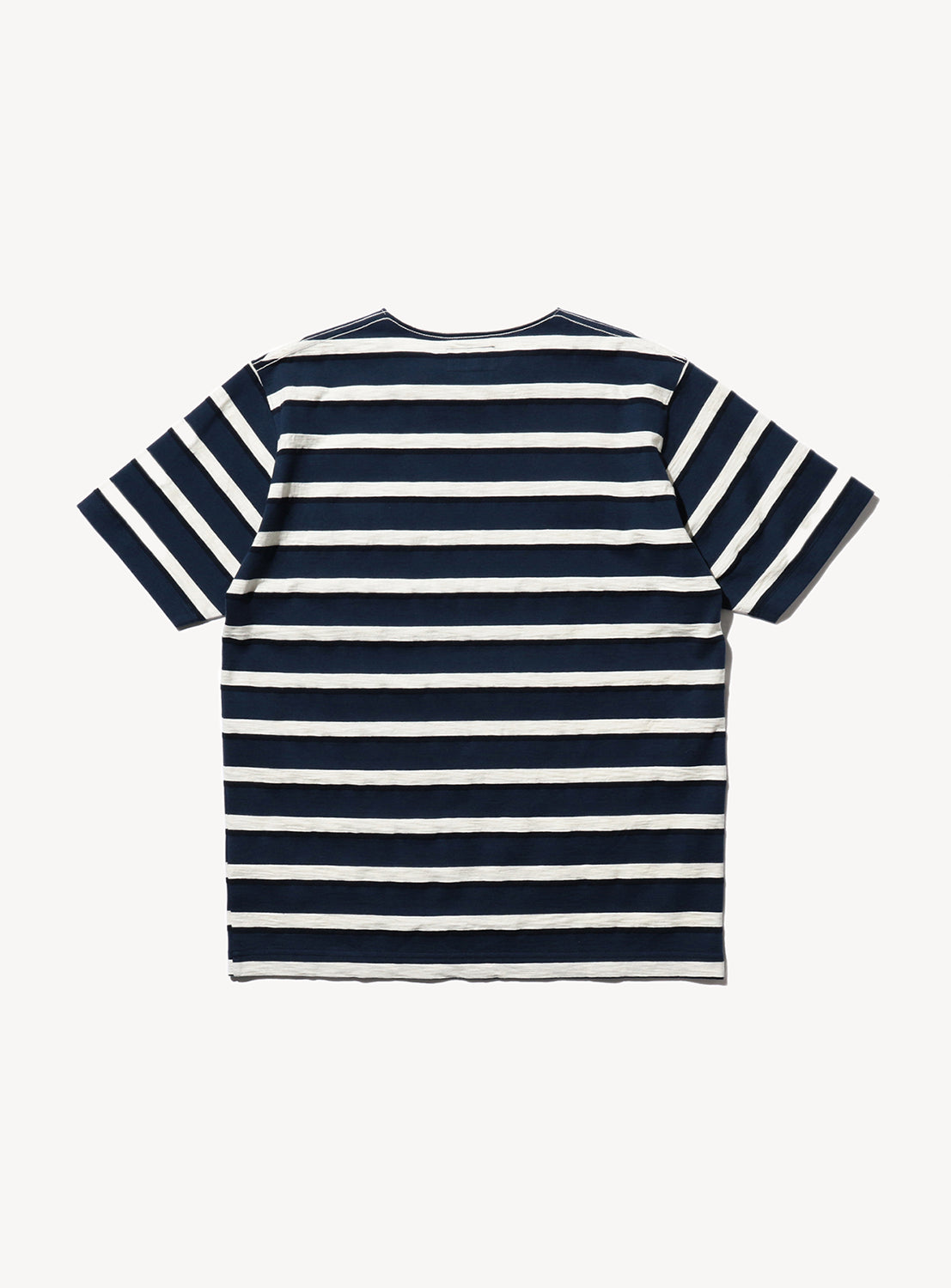 Back of a striped Pocket Tee with navy blue and white horizontal stripes, short sleeves, and a round neckline.