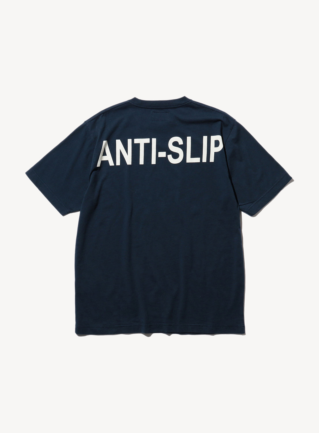 Back of a navy blue t-shirt with the text, 'ANTI-SLIP' in white.