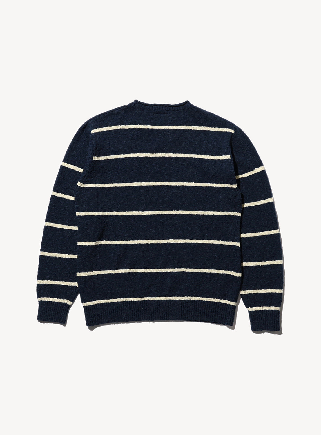 Back of a navy blue striped crew neck sweater with beige horizontal stripes.