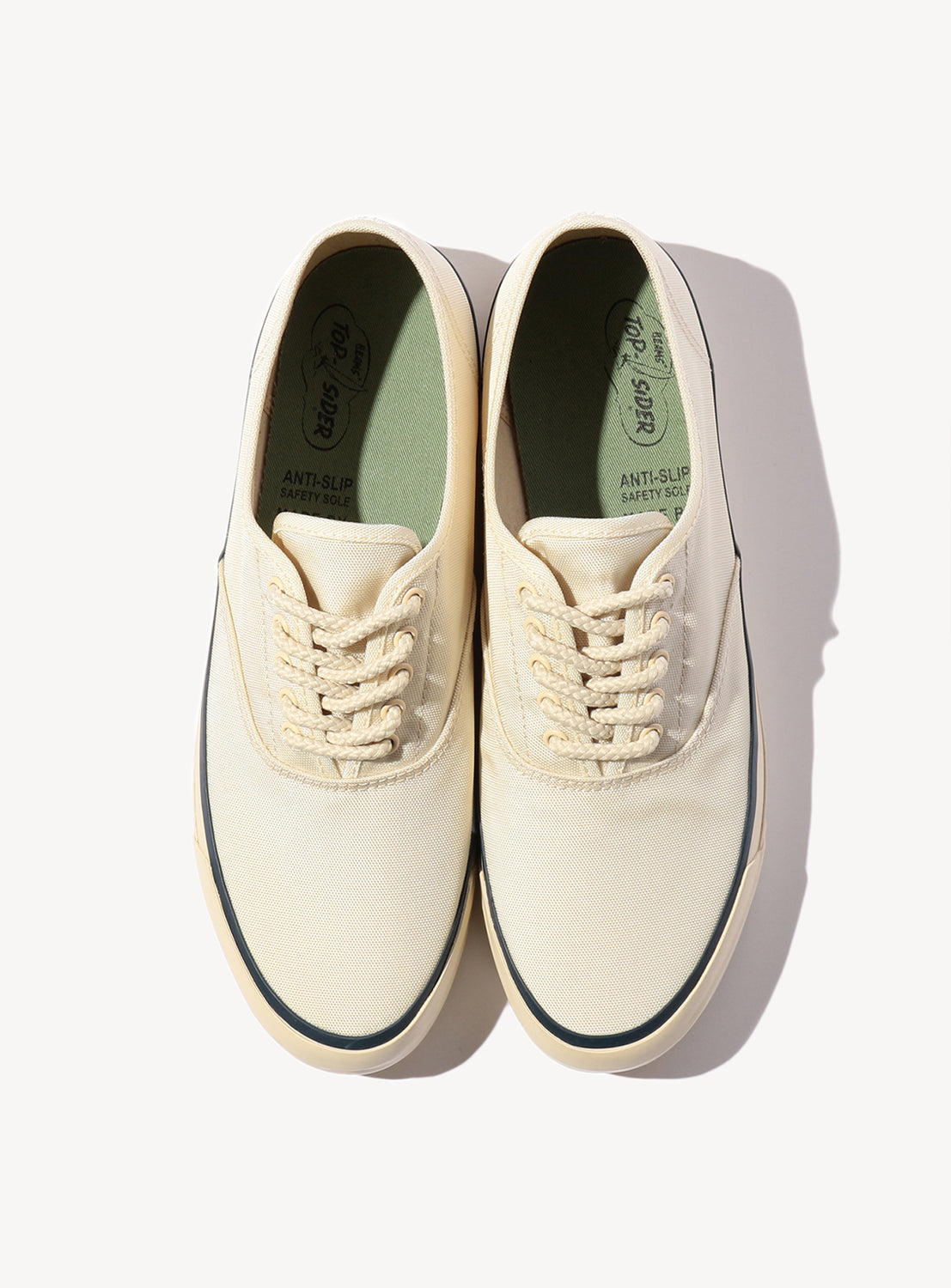 Birdseye view of beige white Sperry showcasing the lace detail and inner sole.