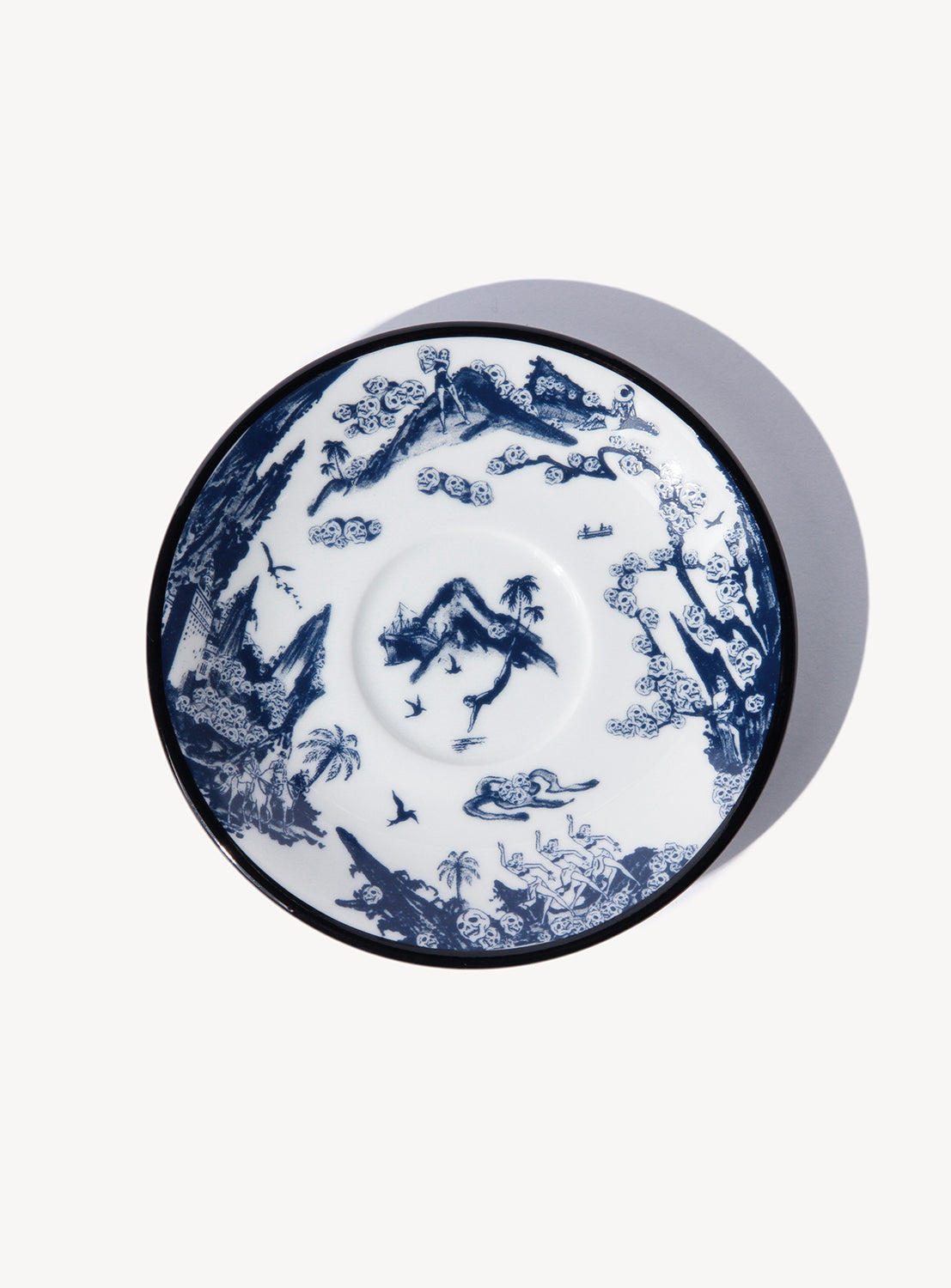 Close-up of a Dokuro series saucer, showcasing the dramatic contrast between the white glaze and deep blue gosu.