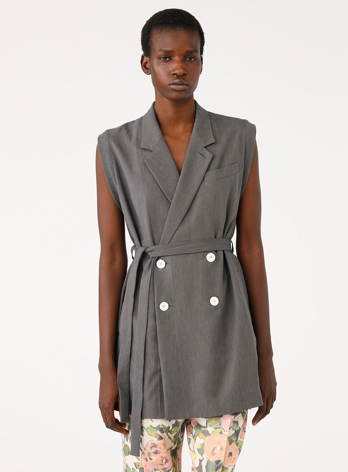 Model wearing a grey gilet with a tie waist.