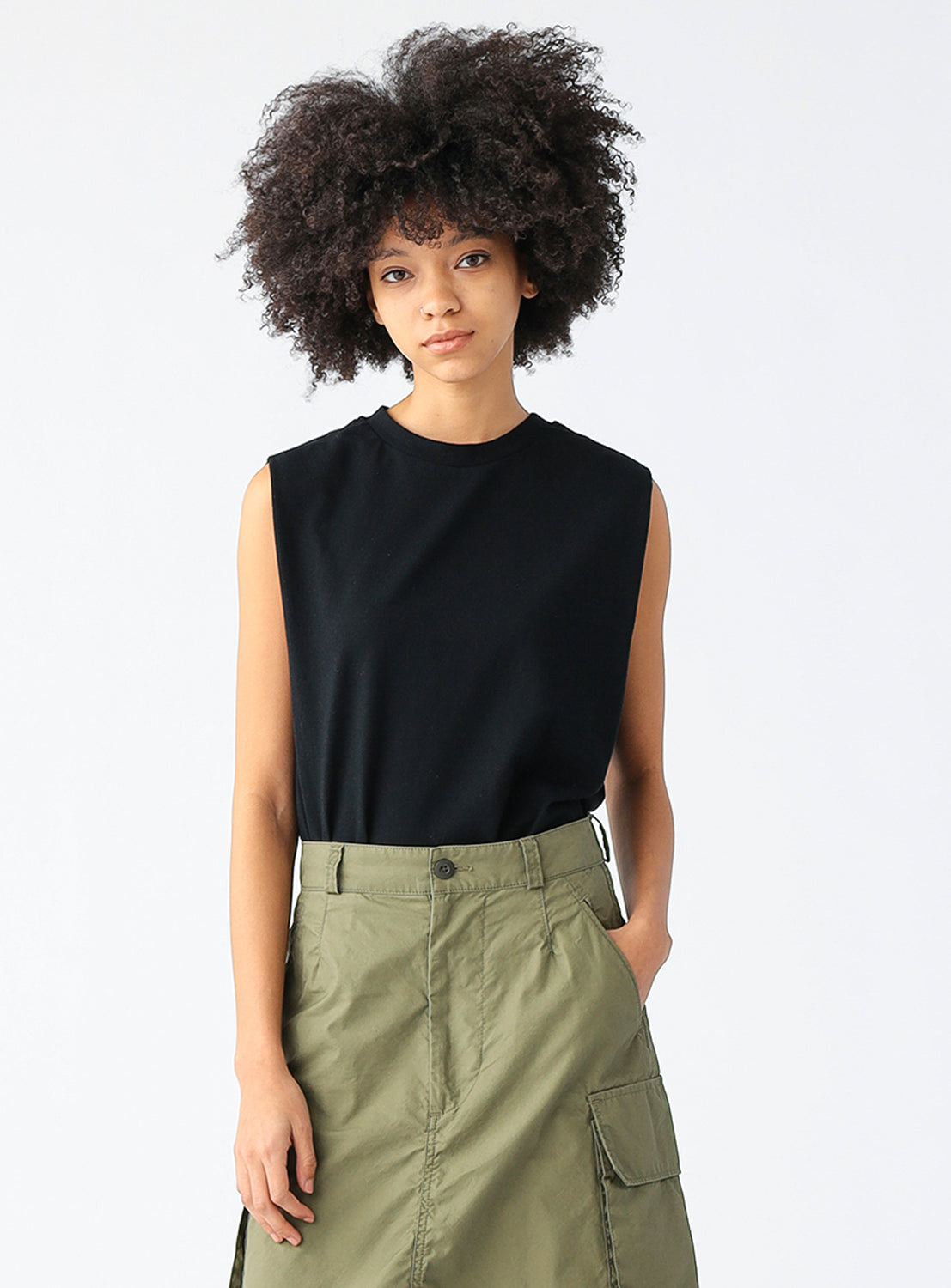 Model wearing a black t-shirt sleeveless top.