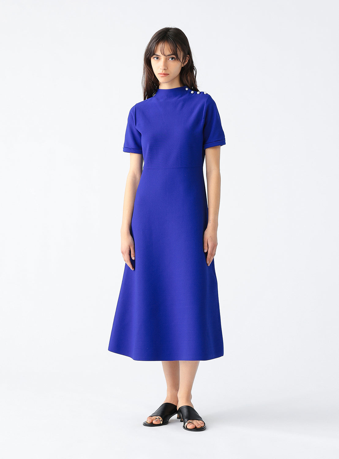 Full front view of a model wearing a blue knit dress.