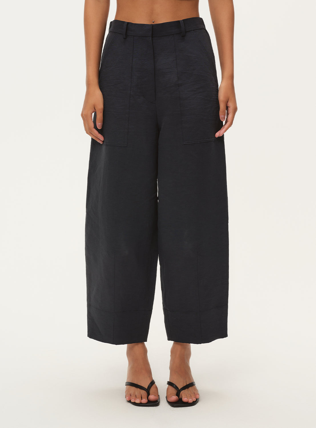 Model showcasing the relaxed fit and cropped length of the navy blue wide-leg pants from the front.