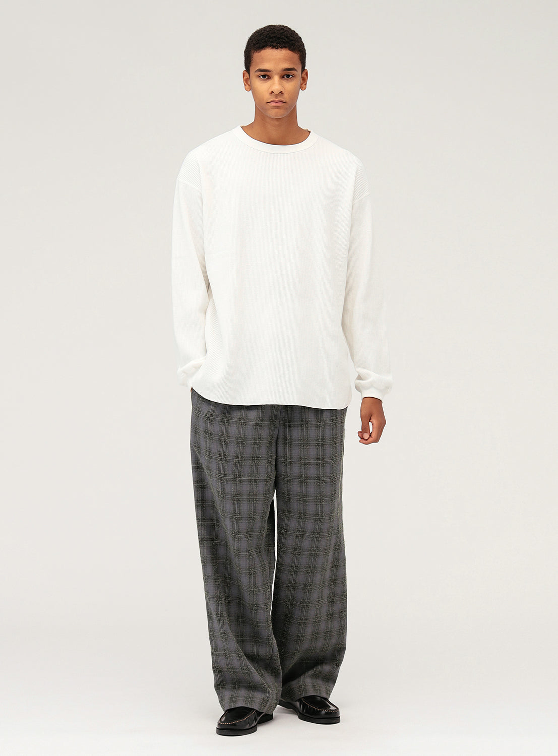 Model wearing charcoal grey plaid pants.