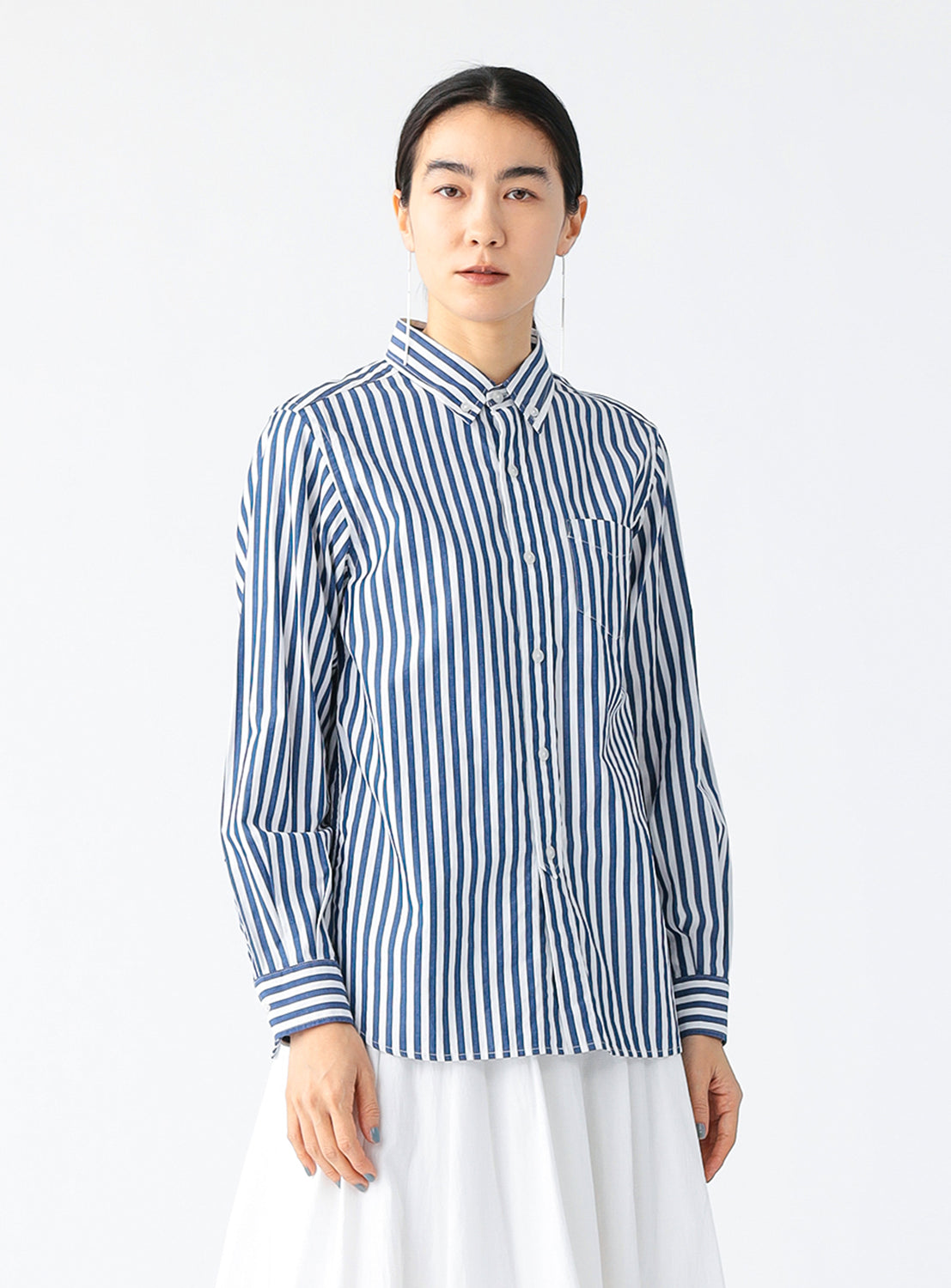 A model wearing a blue and white striped button-down shirt for women.