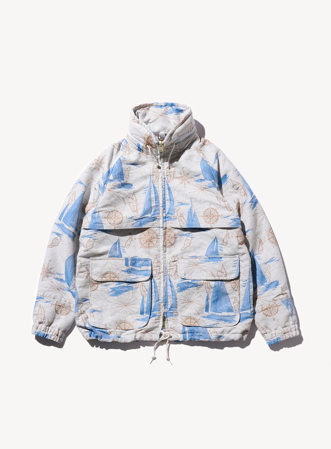 A jacket with a multicolored sailboat pattern, featuring a hood, pockets, and a zipper.