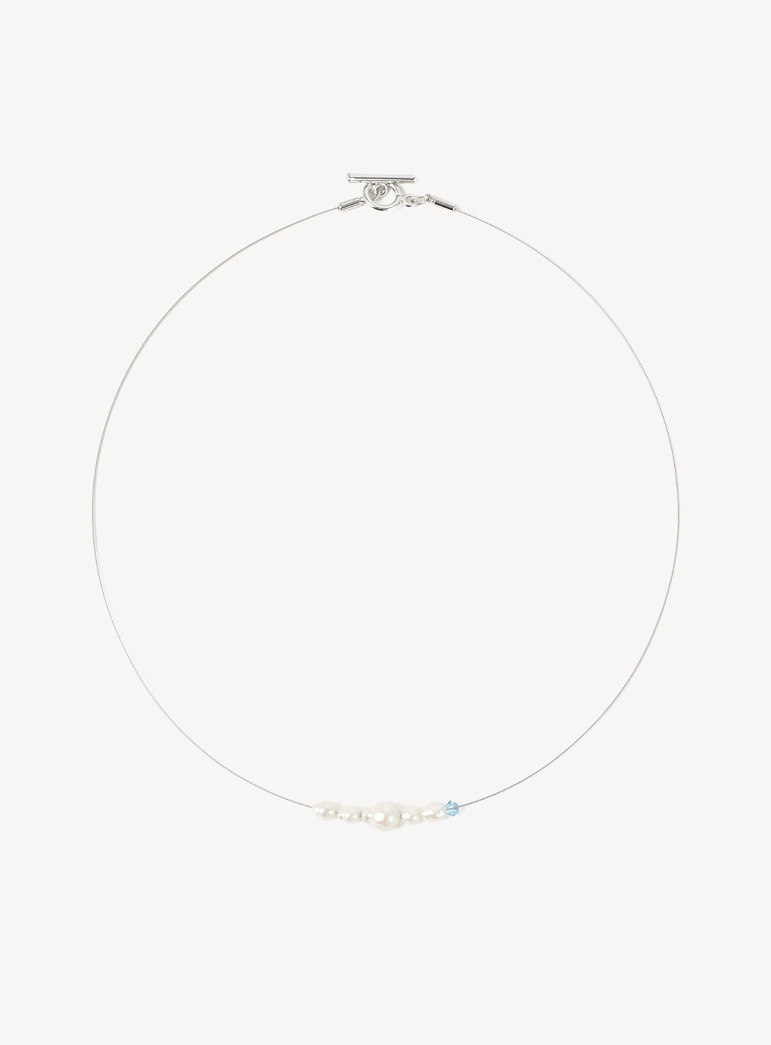 The Ray BEAMS Glass Pearl and Delicate Wire Necklace showcases a lightweight, slender wire frame with a central accent of dainty white glass pearls and a single light blue bead, displayed against a white background.