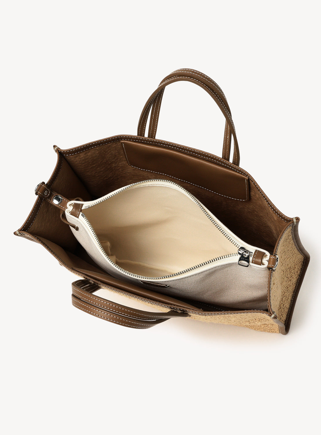 Interior of the tote bag featuring the middle pouch and its zipper detail.