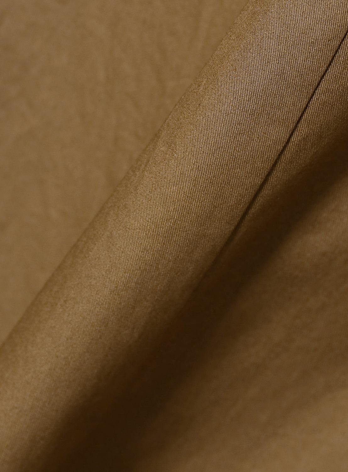 Up-close texture shot of the khaki dress material, emphasizing its quality.
