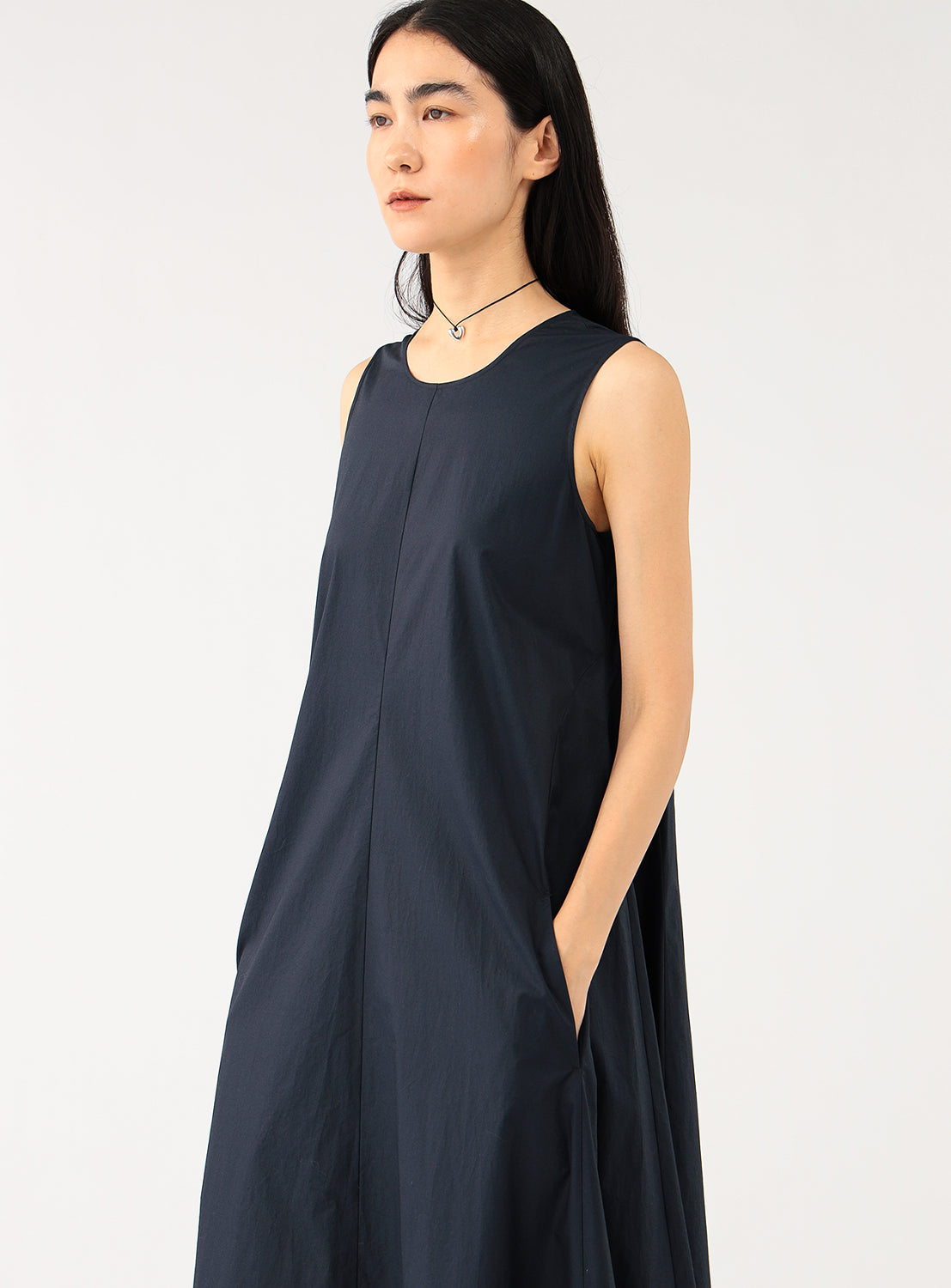 Front view of a model showcasing a simple yet elegant navy maxi dress with a relaxed fit.