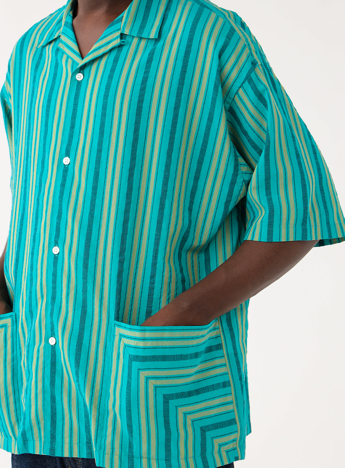 Dobby Stripe Open Collar Shirt teal BEAMS. Close-up of teal shirt fabric with green stripes, detailing the woven pattern and a contrasting button.