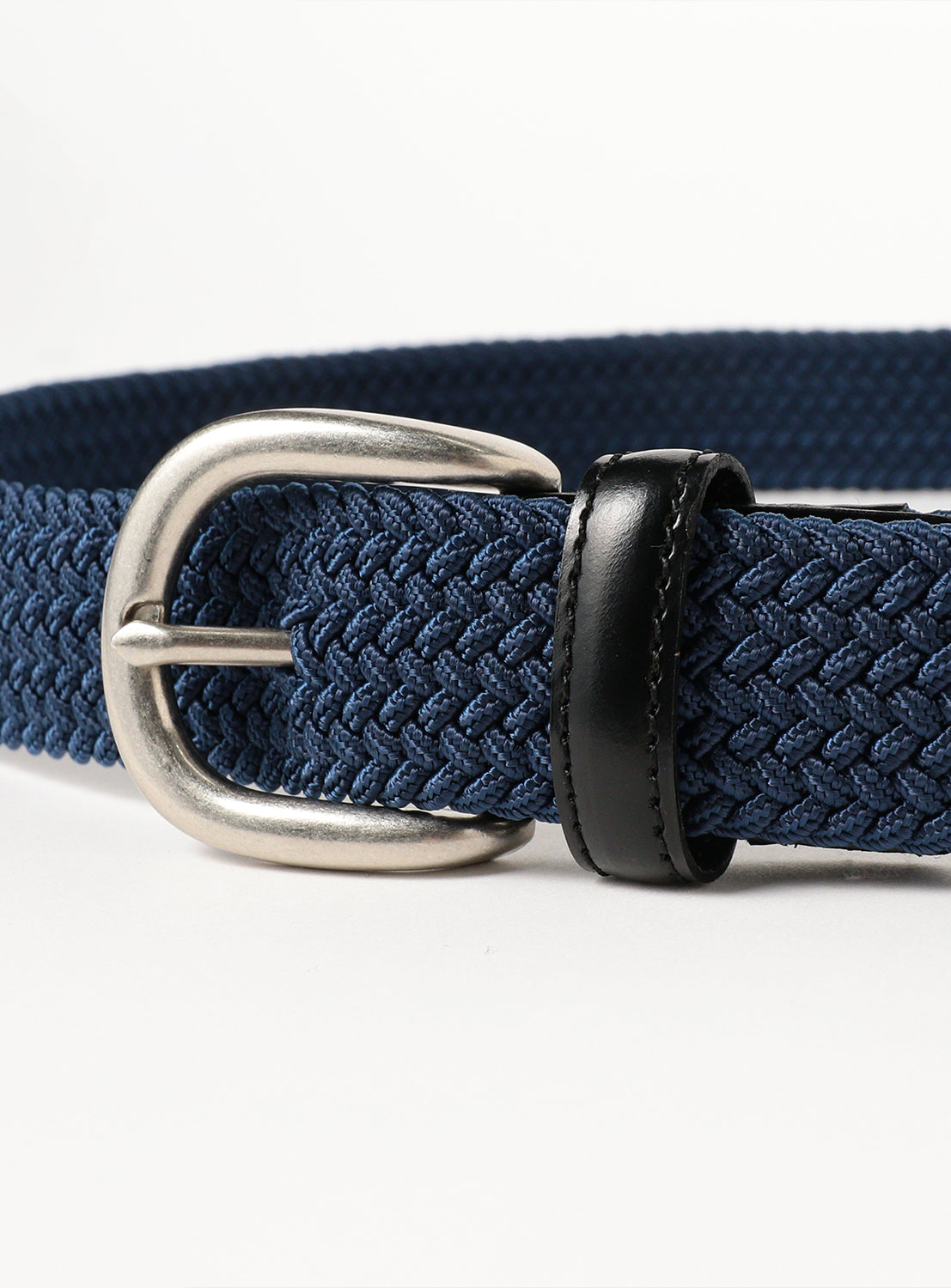 Close up of the silver buckle and belt material.