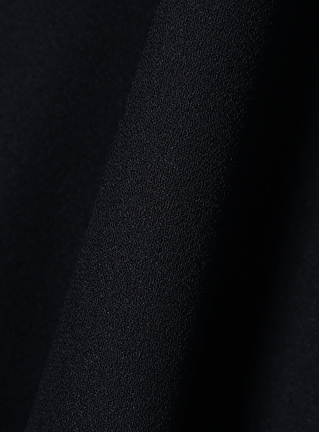 Close-up of black textured fabric.