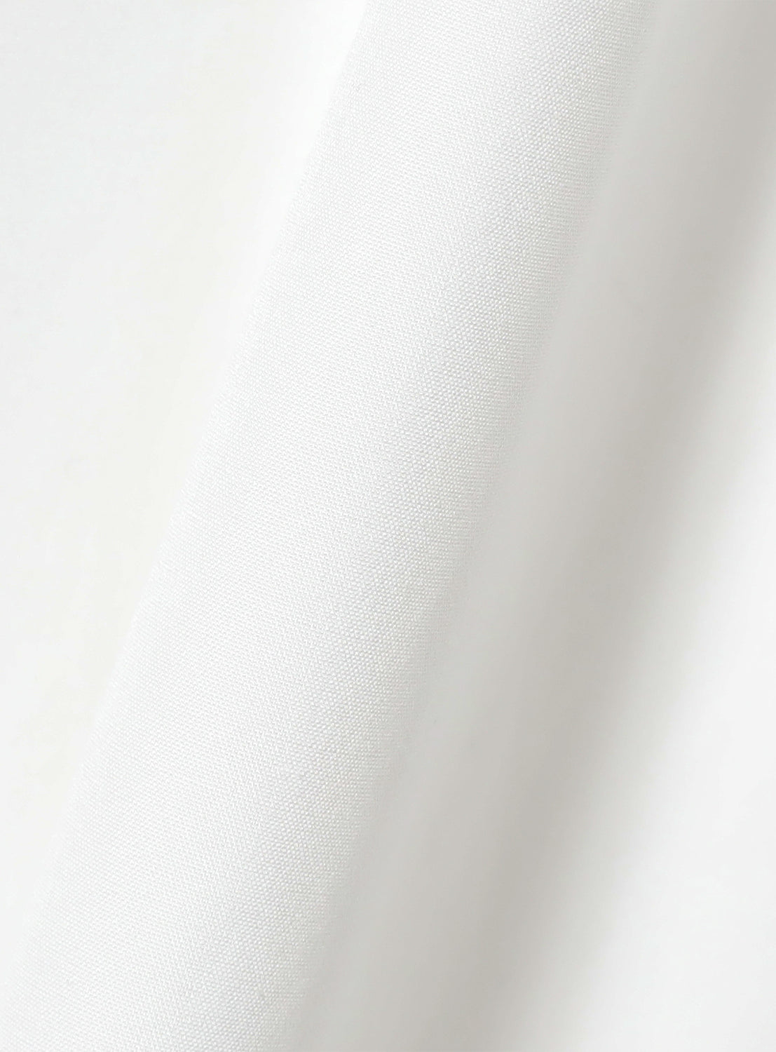 Close up of the material of the white blouse.