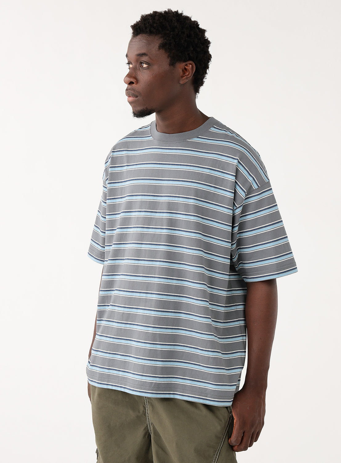 Model showcasing the front of the striped shirt with a relaxed, boxy fit.