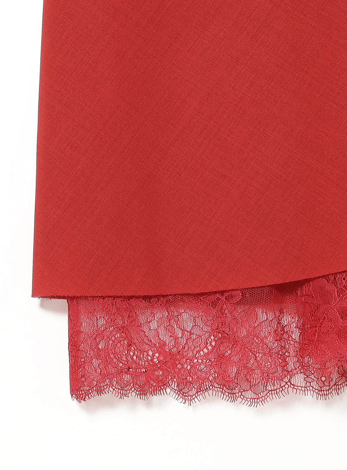 Bottom of red skirt with red lace trim.