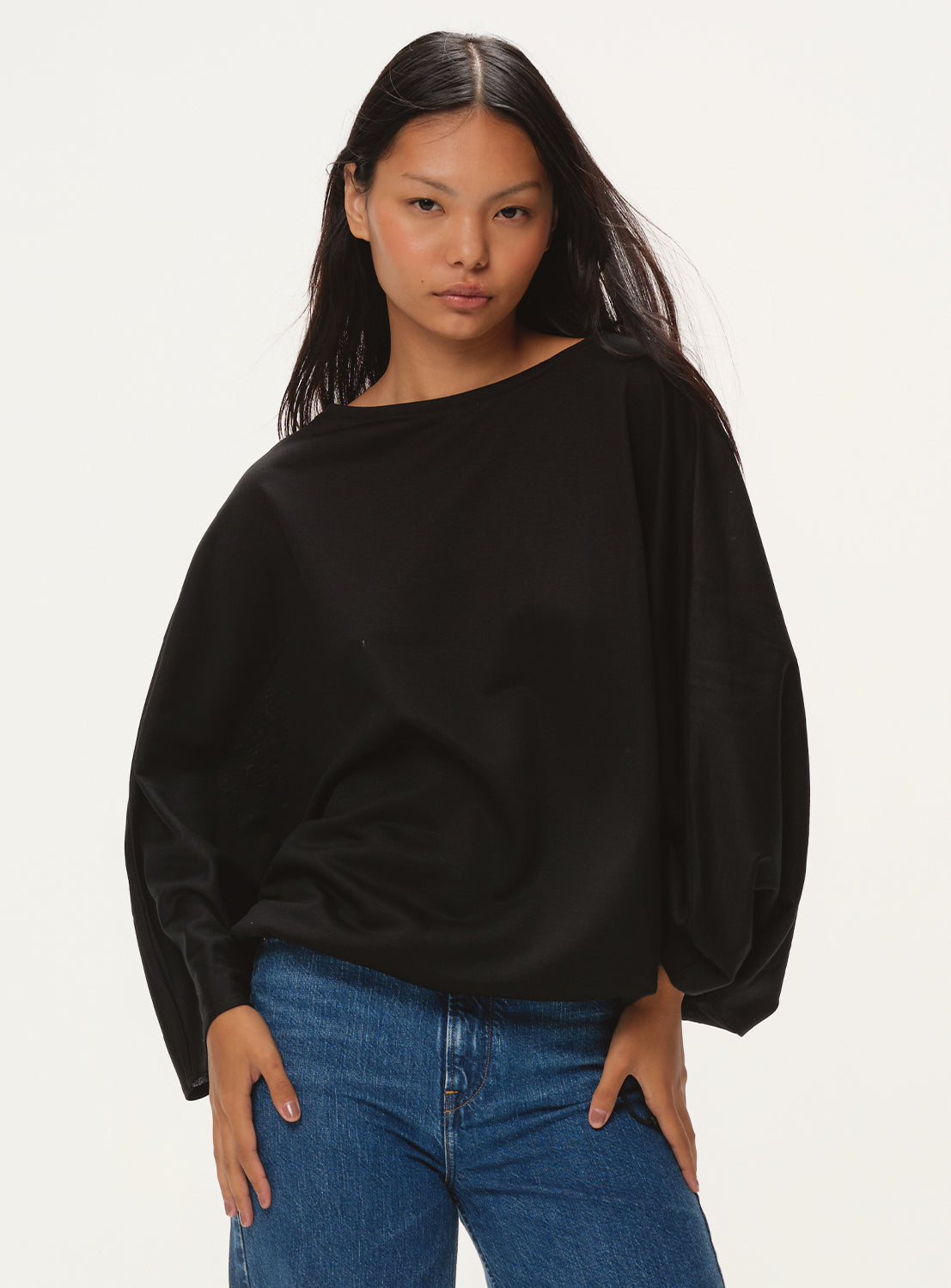 Model wearing black oversized diamond shaped t-shirt.