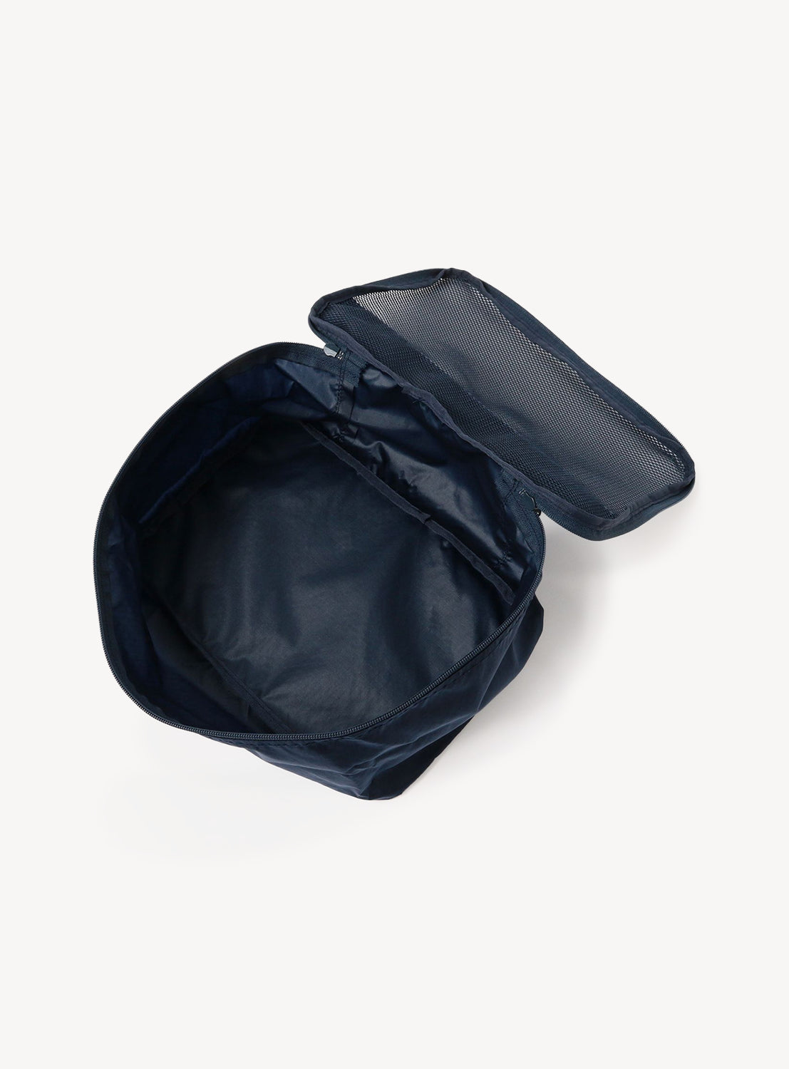 Navy blue travel bag with open lid on a white background