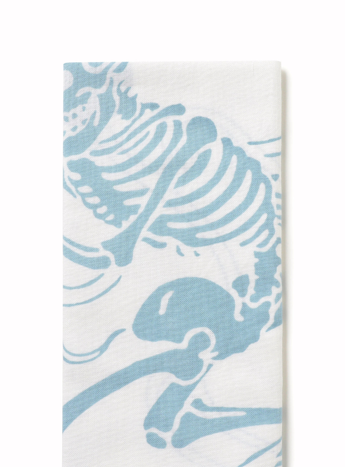 Close-up of a hand towel, highlighting the dynamic and whimsical skeleton graphic in soft blue.