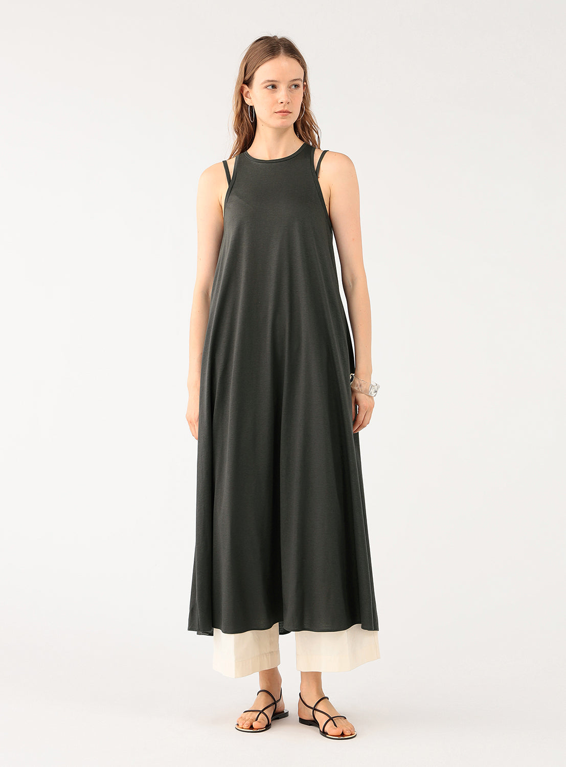 Full body shot of a model wearing a loose-fitting grey maxi dress.