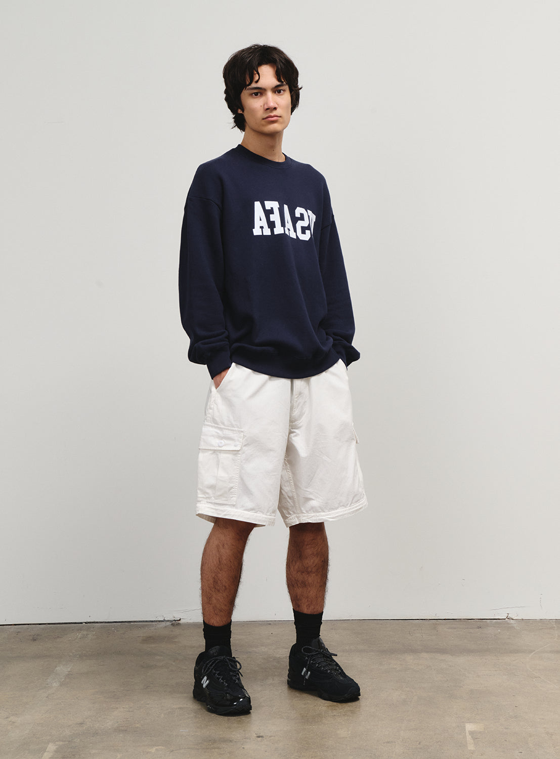 Model in white shorts from the Flying Elephant collection, embodying the spirit of 1990s skate culture.