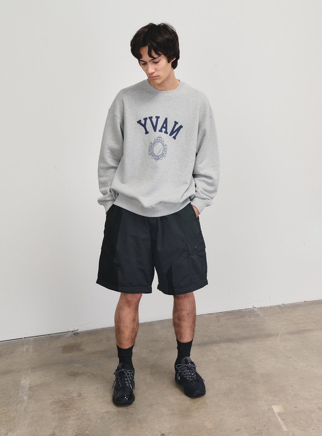 Model wearing the piece as black shorts, showing versatile styling with boots from the SSZ collection.