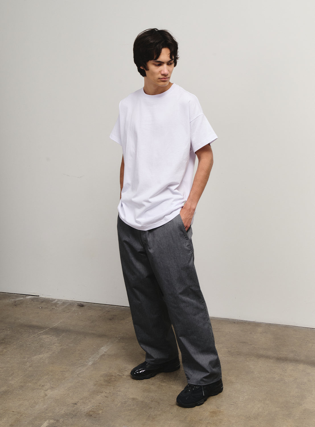 Model front view in grey pants, showcasing the relaxed fit from the SSZ Flying Elephant collection.