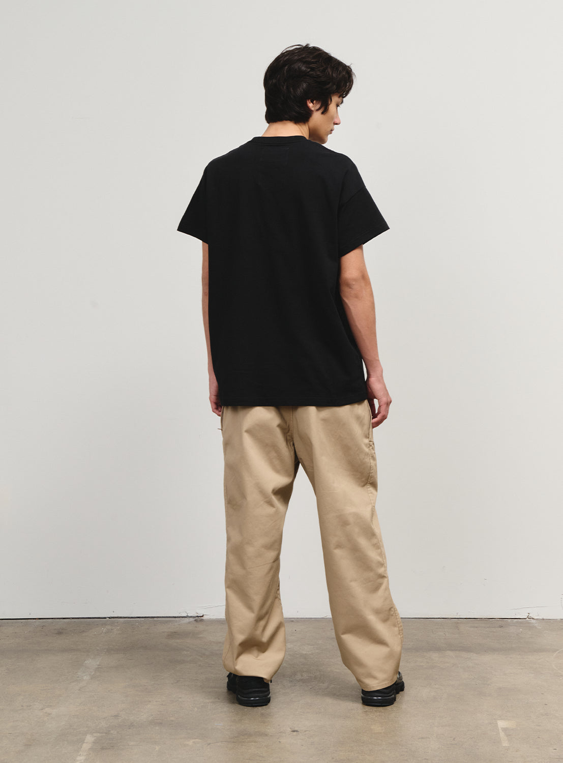 Back view of a model in the khaki pants from the Flying Elephant collection, celebrating a 1990s skate icon.