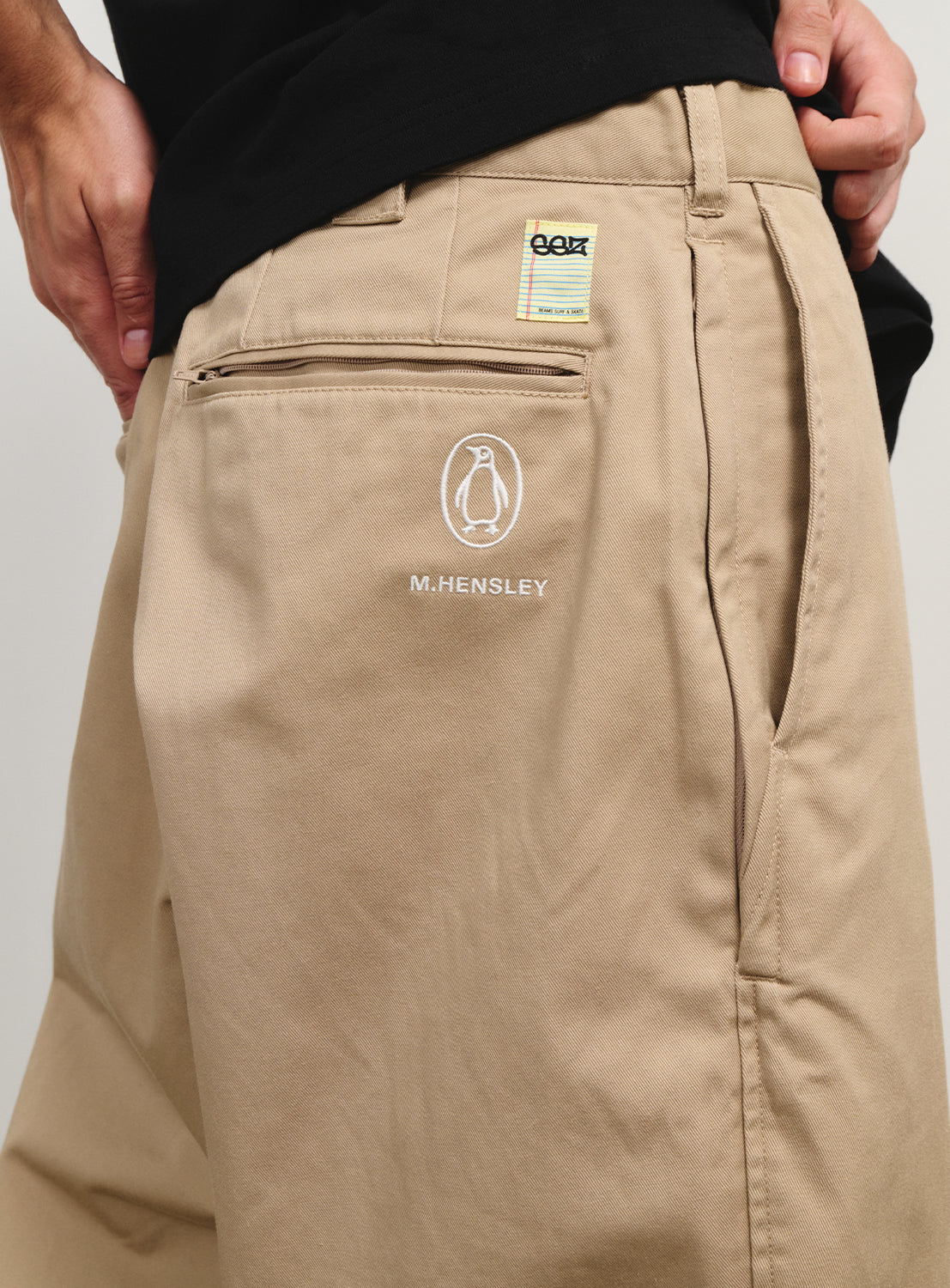 Close-up of the khaki pants, showing the logo from the Matt Hensley collection.