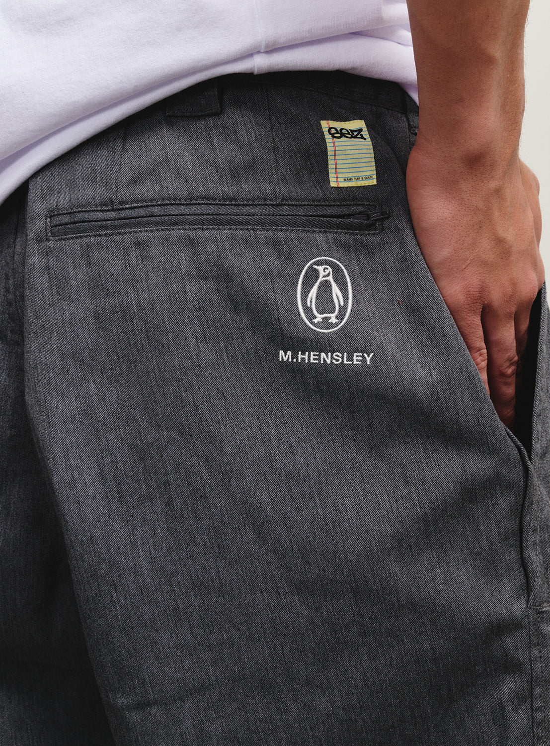Close-up of the grey pants, highlighting the Flying Elephant logo and 1990s skate heritage.