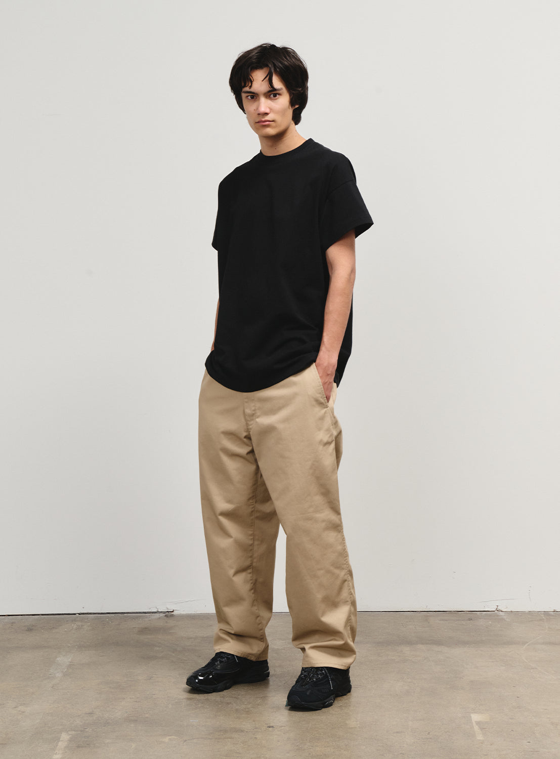 Model wearing khaki pants from the Flying Elephant by Matt Hensley collection, honoring 1990s skate style.