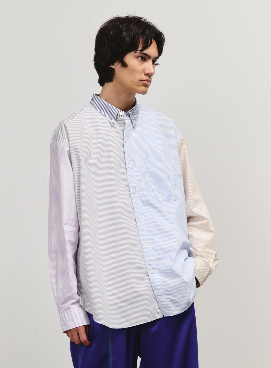 Model wearing a shirt with a color-blocked striped pattern.