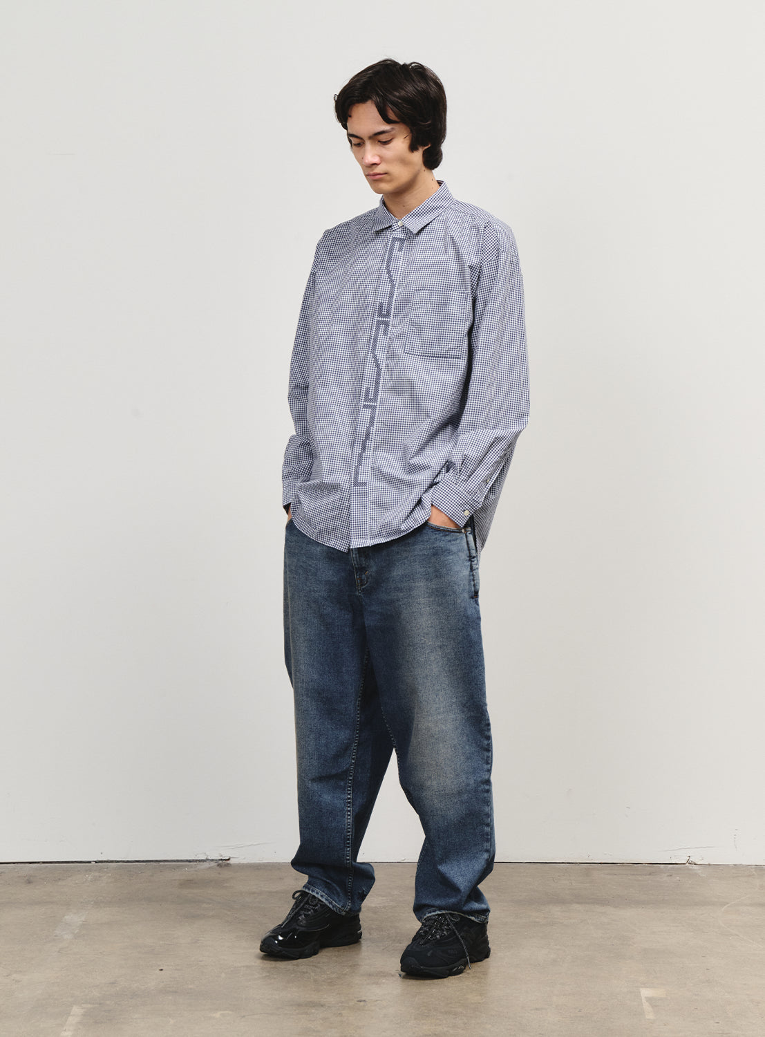 Model wearing blue denim pants, offering a smart twist on a classic silhouette with functional details.