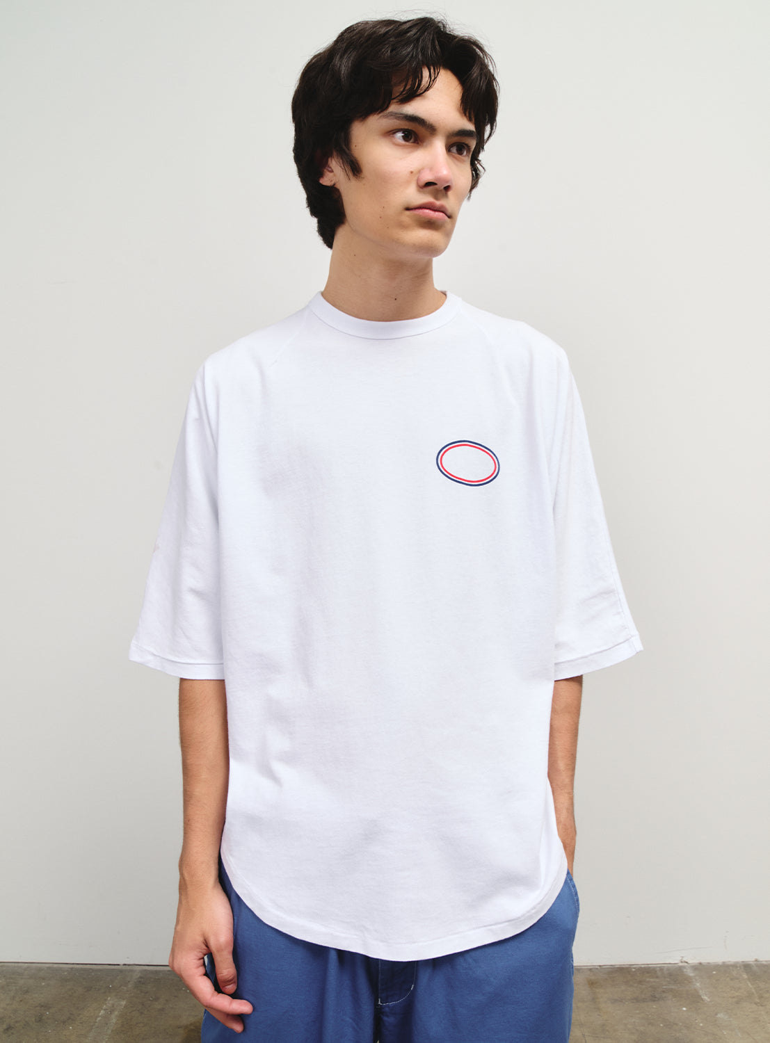 Model wearing a white raglan tee, showcasing its simplicity and SSZ's "NO OPERATION" ethos.
