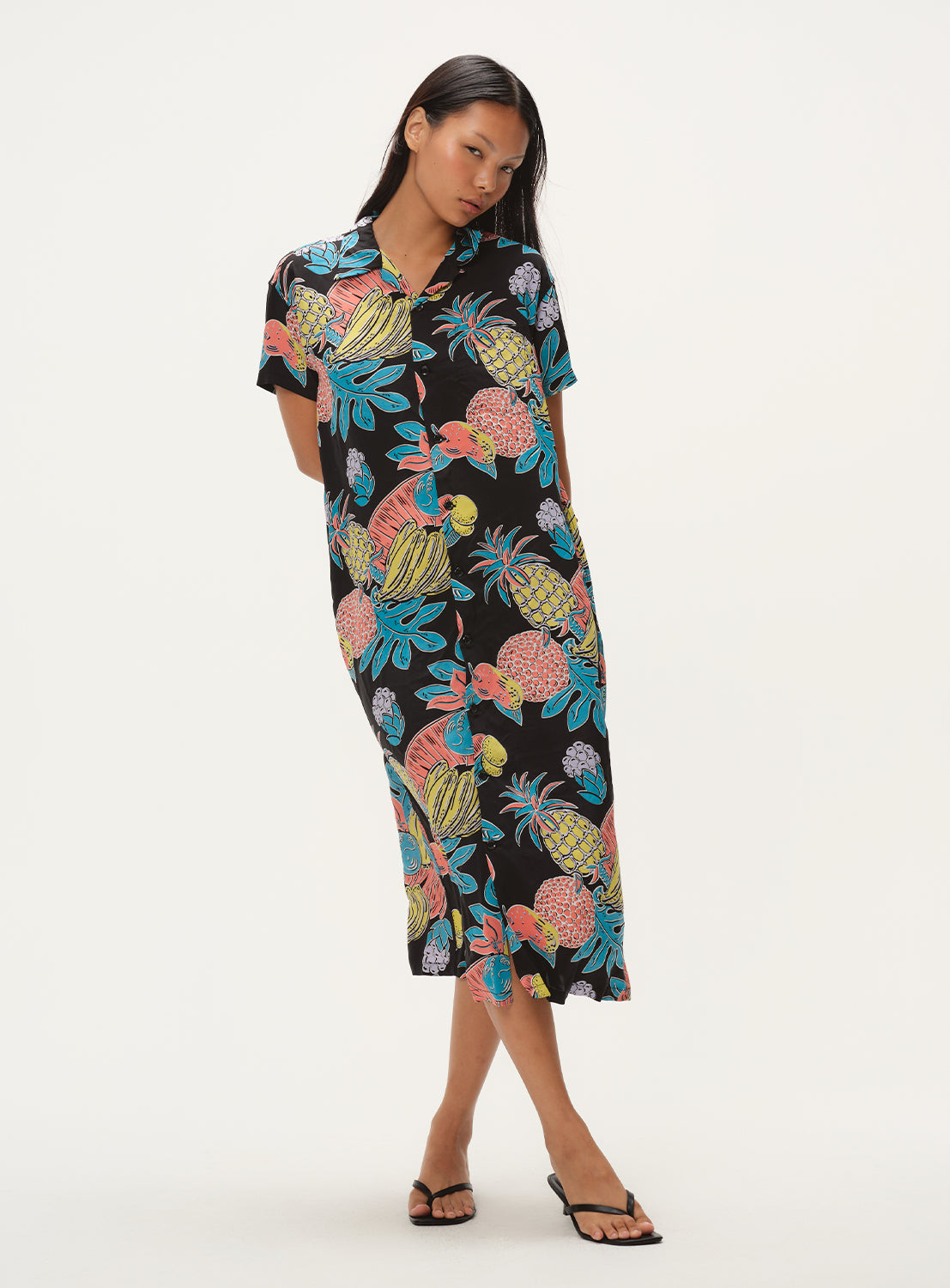 Full body shot of a model wearing a black patterned shirt dress, highlighting the fit and design.